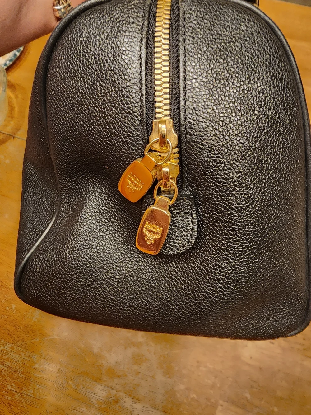 MCM Black Leather Boston Bag featuring polished gold-tone hardware
